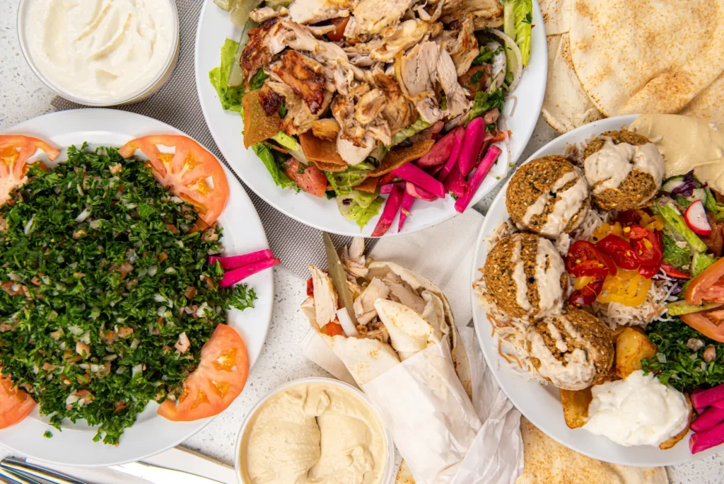 Turkish feast with chicken shawarma, falafel plate, tabbouleh, hummus, wrap and pita
