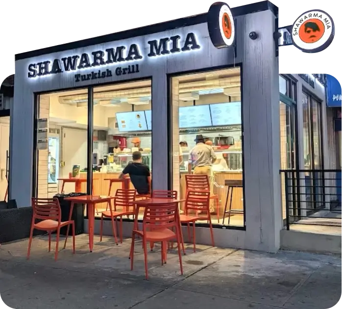 Shawarma Mia Turkish Grill storefront with orange outdoor seating and customers ordering at the counter